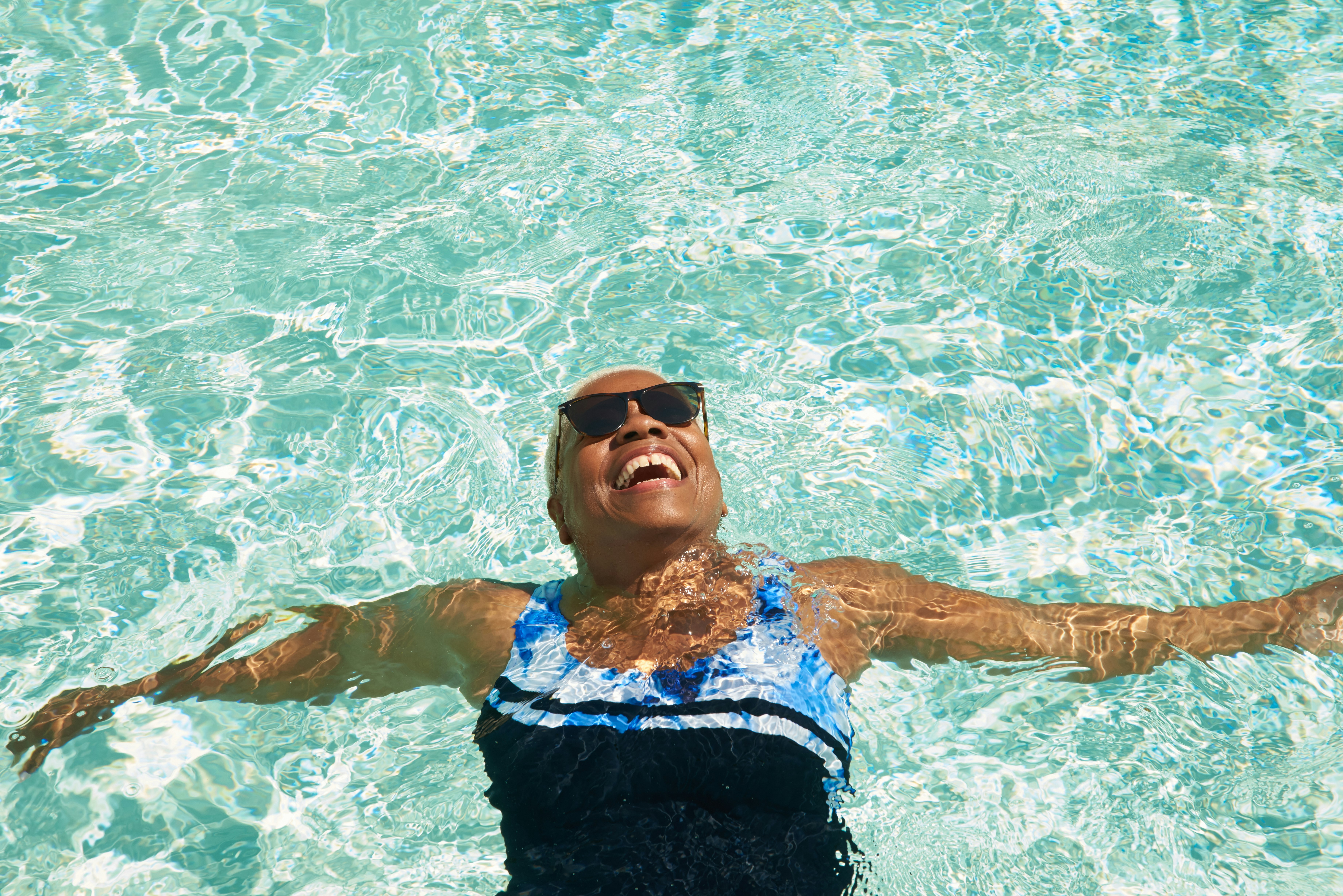 A mature woman relaxes in a swimming pool
