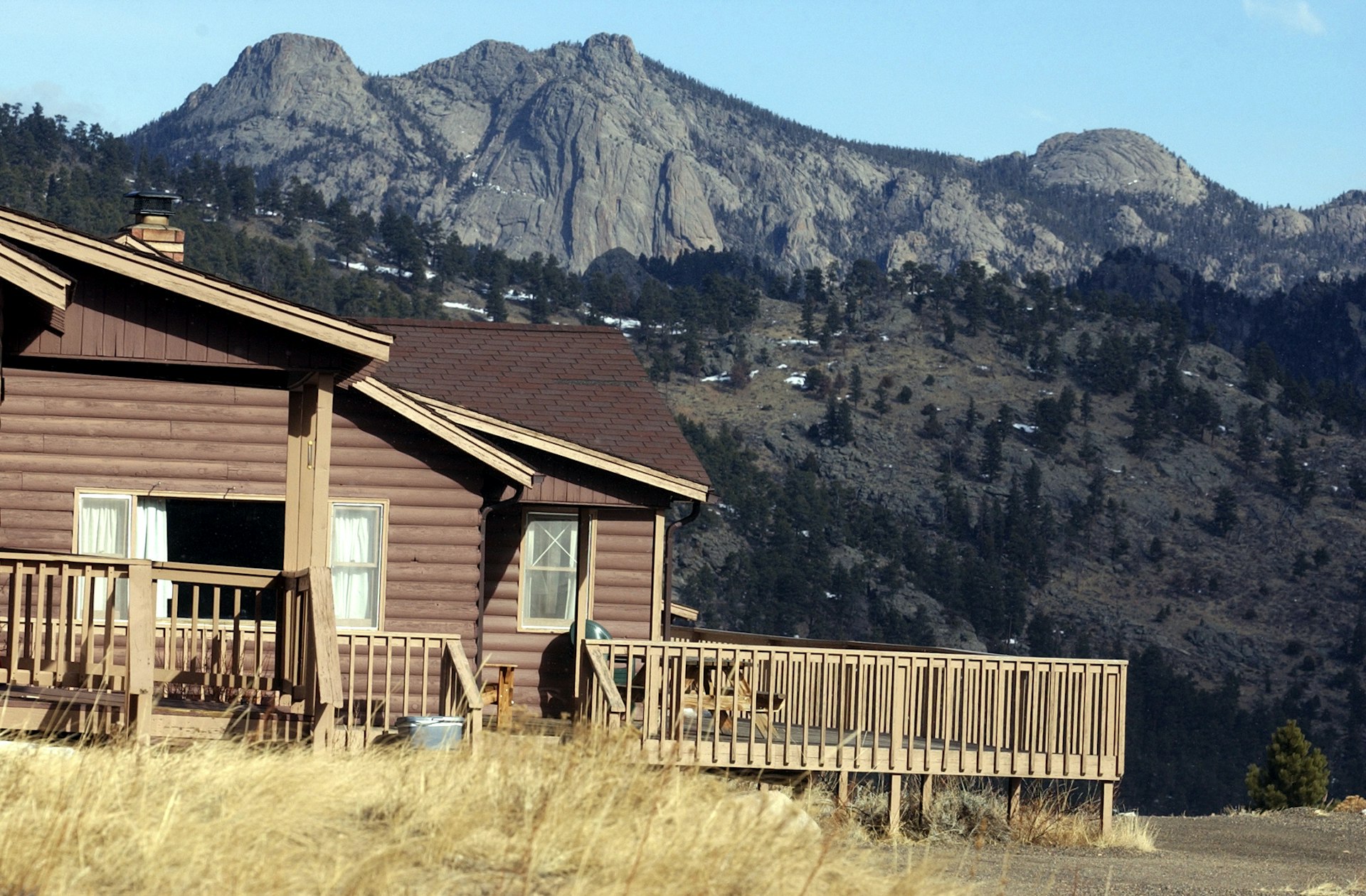 One of many cabins at the YMCA of The Rockies near Estes Park. In the background you can see the iconic Rocky Mountains.  