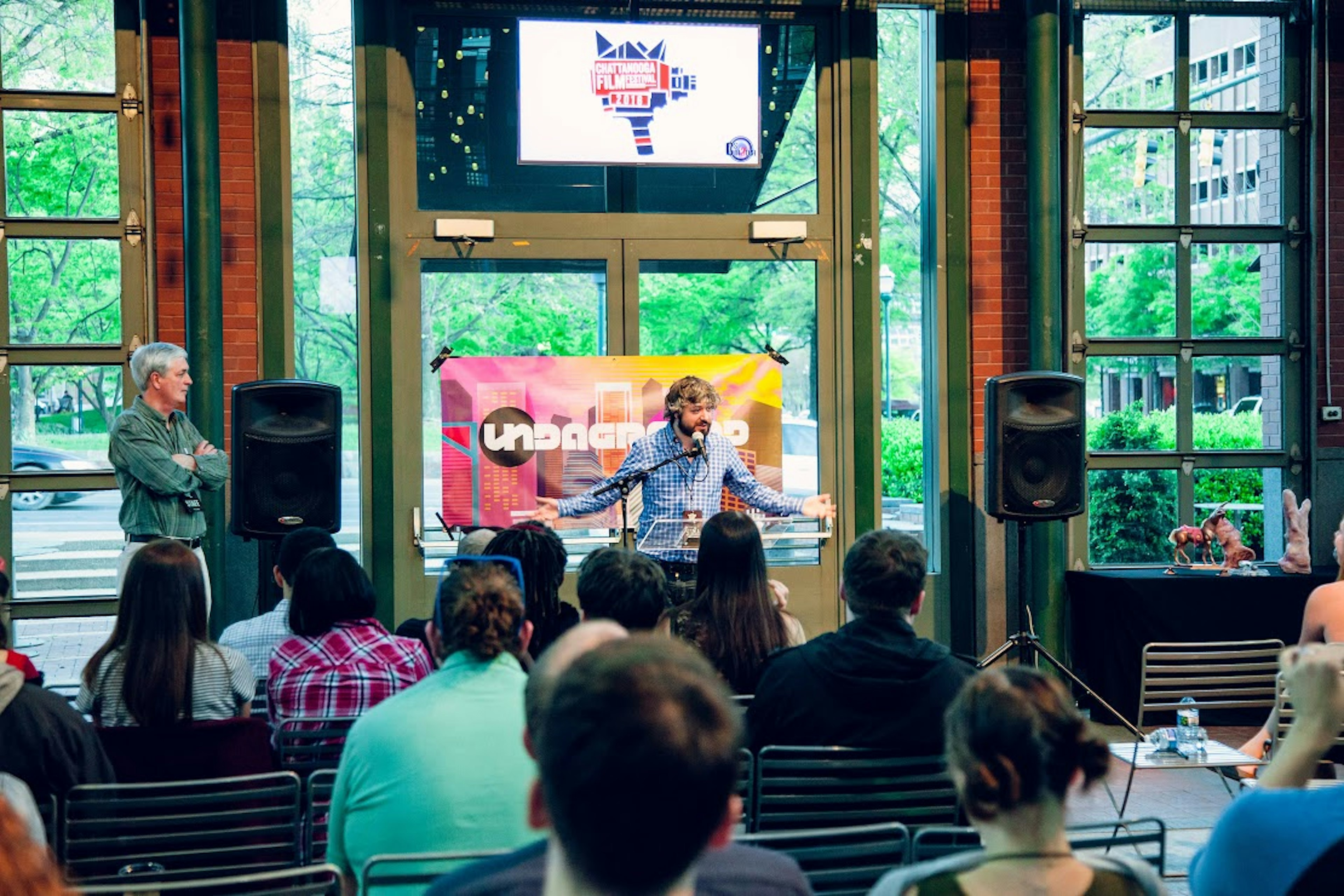 Chris Dortch Sr., left, looks on as Chris Dortch II, the director of the Chattanooga Film Festival, welcomes attendees at the Waterhouse Pavilion in downtown Chattanooga, Tennessee