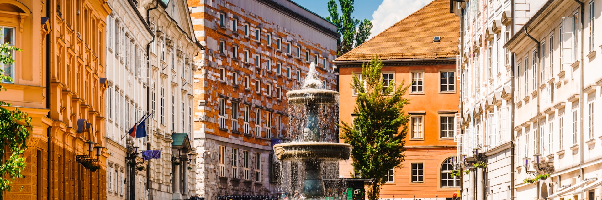 View on building and fountain next to fountain novi trg square in Ljubljana