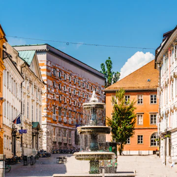 View on building and fountain next to fountain novi trg square in Ljubljana
