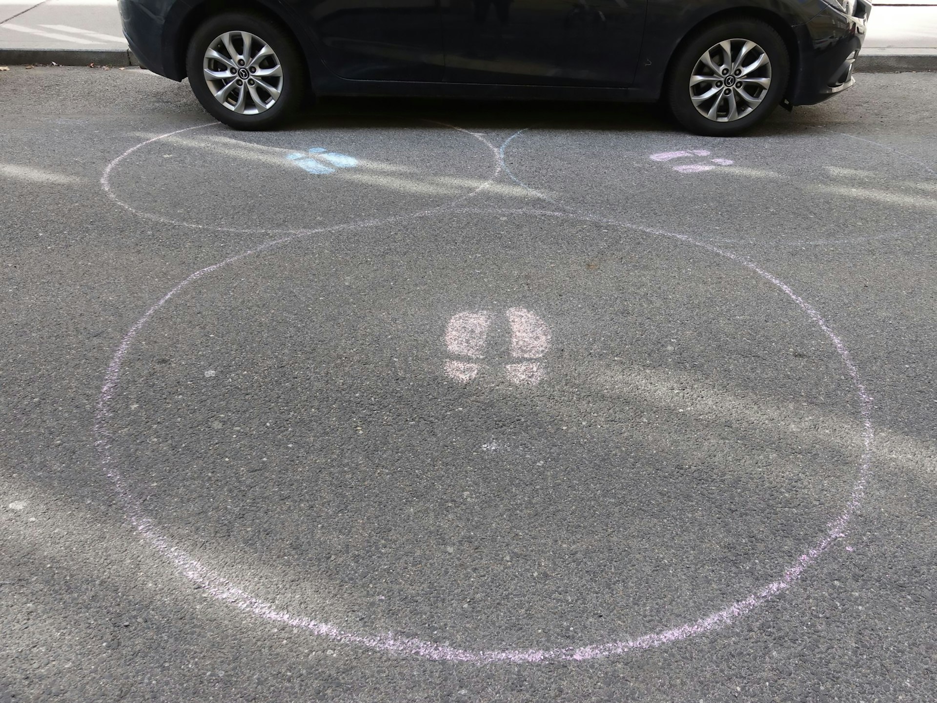 A picture of a social distancing bubble drawn on a street