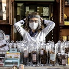 ROME, ITALY - MAY 02: Assunta owner of the herbalist's shop Il Germoglio is portrayed while adjusting her protective gear against Covid-19 on May 2, 2020 in Rome, Italy. Italy will remain on lockdown to stem the transmission of the Coronavirus (Covid-19), slowly easing restrictions. Following the announcement made by Italy’s Prime Minister Giuseppe Conte from 4 May people will be allowed to do outdoor exercise and the chance to visit family members, all while maintaining social distancing. Gatherings of any kind, private or public, will remain strictly banned. Public parks, gardens and villas will reopen but mayors will have the power to close them if necessary. People will be allowed to walk and jogging away from their home so long as they practice social distancing: two metres apart for joggers, one metre for walkers. Restaurants and bars will be allowed to operate a take-away service - in addition to home delivery which is already permitted.(Photo by Alessandra Benedetti - Corbis/Corbis via Getty Images)