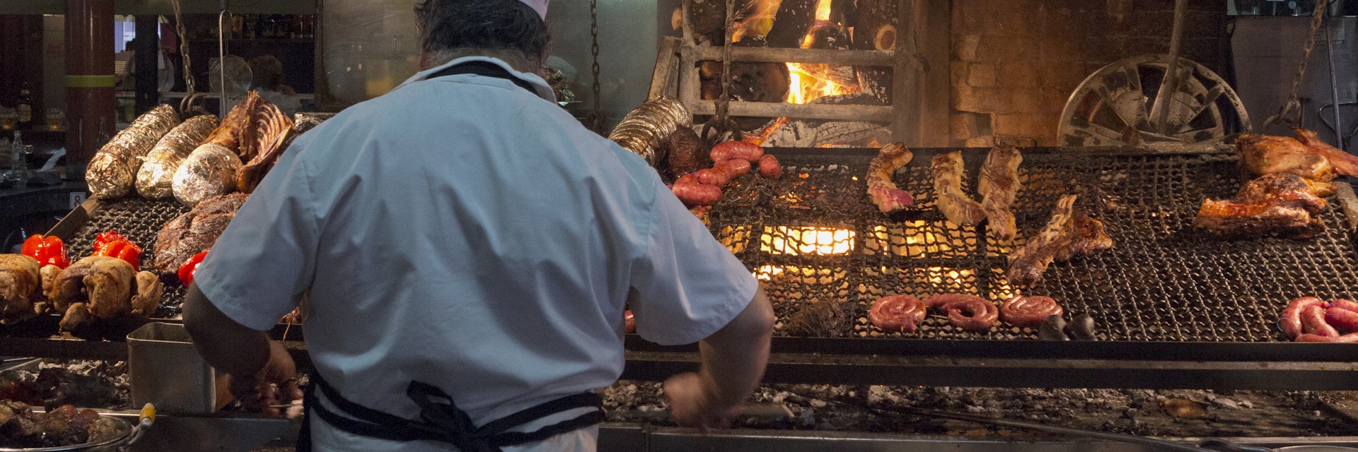 'Parilla' Barbeque Restaurant In The Mercado Del Puerto, Montevideo, Uruguay. (Photo by: Julio Etchart/Majority World/Universal Images Group via Getty Images)