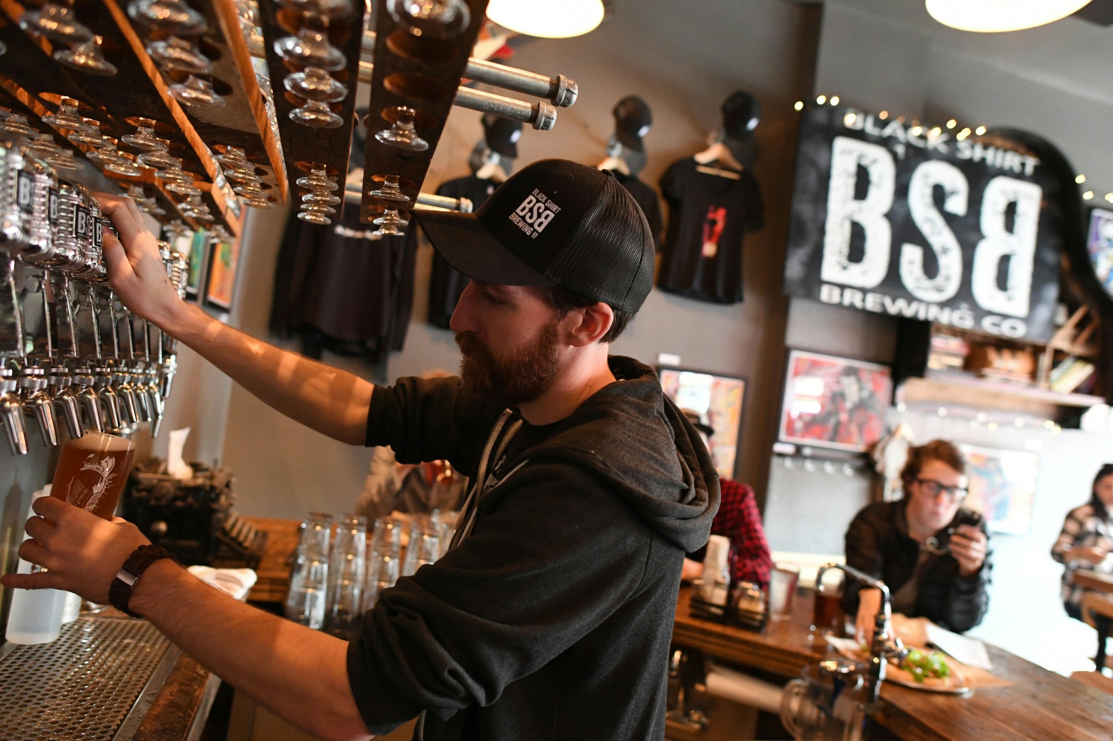 DENVER, CO - SEPTEMBER 28: Sean Cassidy, of Black Shirt Brewing, pours a beer for a customer on September 28, 2017 in Denver, Colorado.The craft beer industry is a $1 billion engine in Colorado's economy. (Photo by RJ Sangosti/The Denver Post via Getty Images)