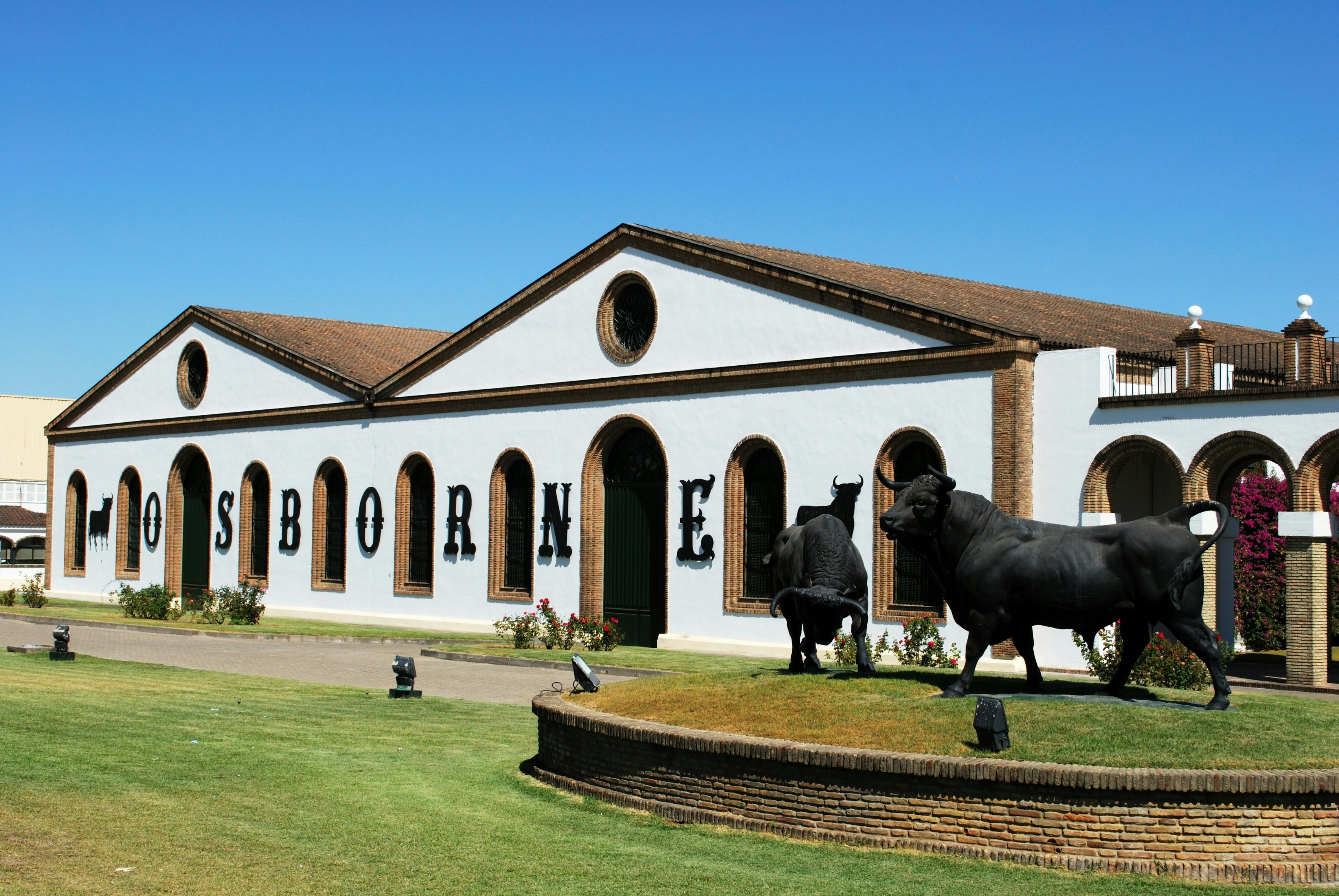 El Puerto de Santa Maria, Spain - August 20, 2008: View of the Osborne Bodega (Bodega El Tiro) with a bull statue in the foreground, El Puerto de Santa Maria, Cadiz Province, Andalusia, Spain, Western Europe.