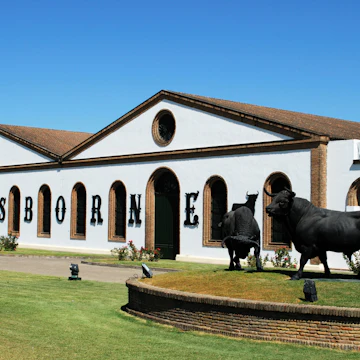 El Puerto de Santa Maria, Spain - August 20, 2008: View of the Osborne Bodega (Bodega El Tiro) with a bull statue in the foreground, El Puerto de Santa Maria, Cadiz Province, Andalusia, Spain, Western Europe.
