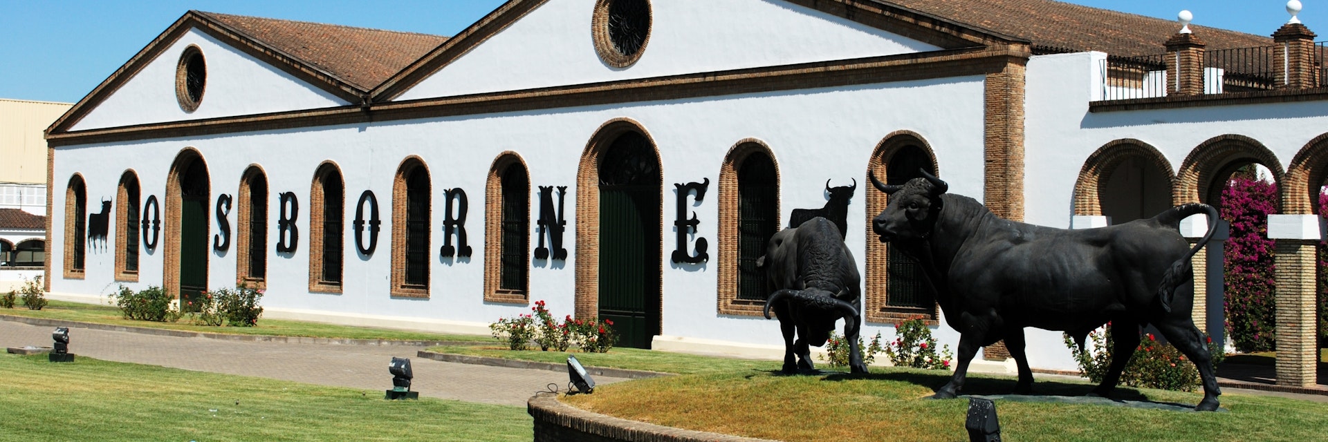 El Puerto de Santa Maria, Spain - August 20, 2008: View of the Osborne Bodega (Bodega El Tiro) with a bull statue in the foreground, El Puerto de Santa Maria, Cadiz Province, Andalusia, Spain, Western Europe.