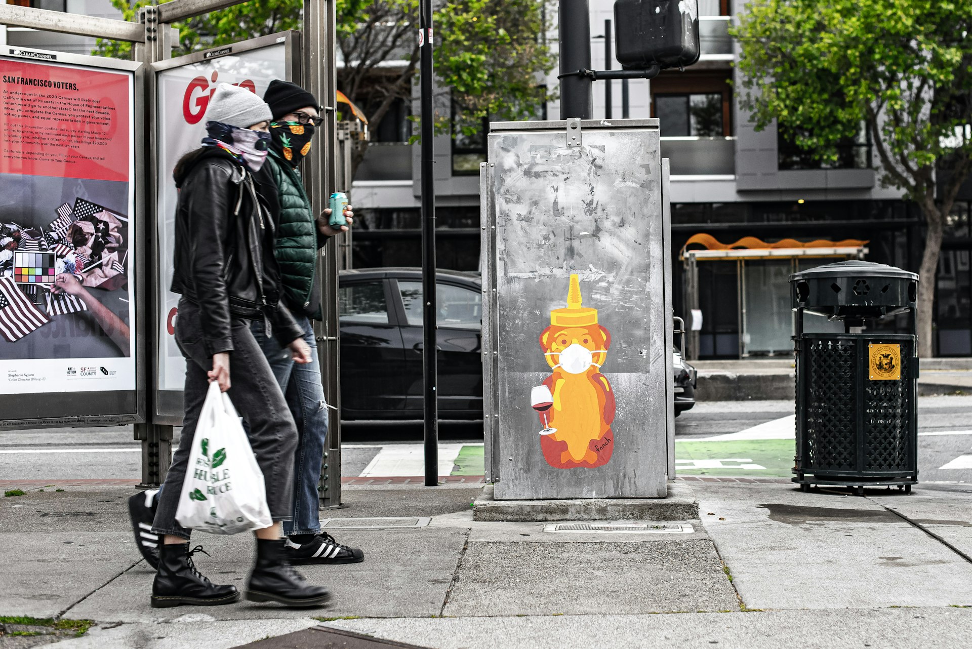 A Wine Bear by fnnch on a mailbox in San Francisco, with two people walking by
