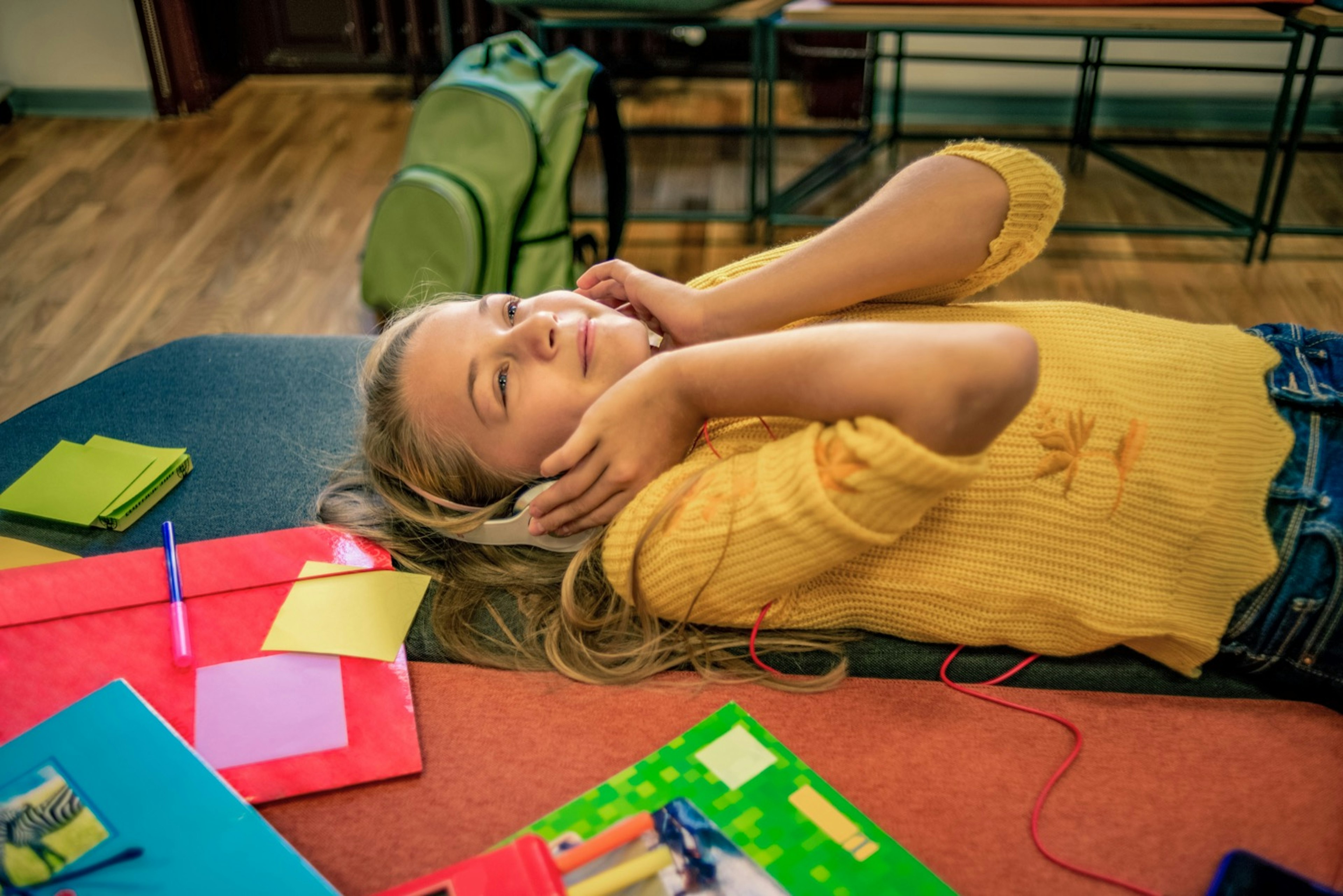 girl relaxing after class and enjoying the music