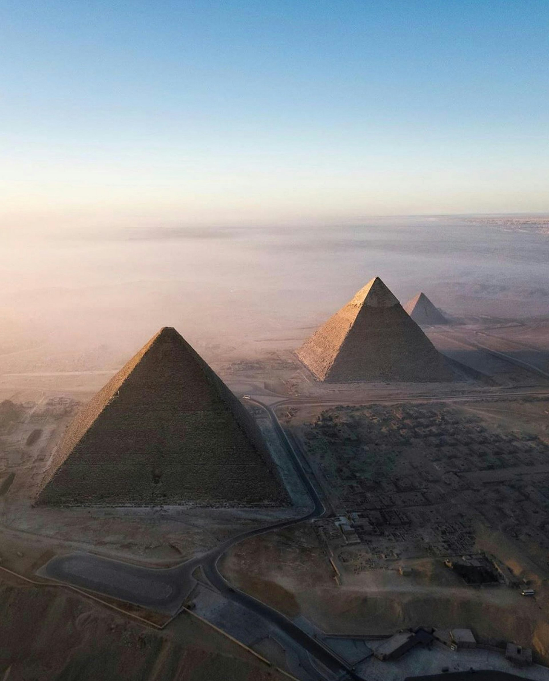 Aerial view of the pyramids of Giza in the desert by day