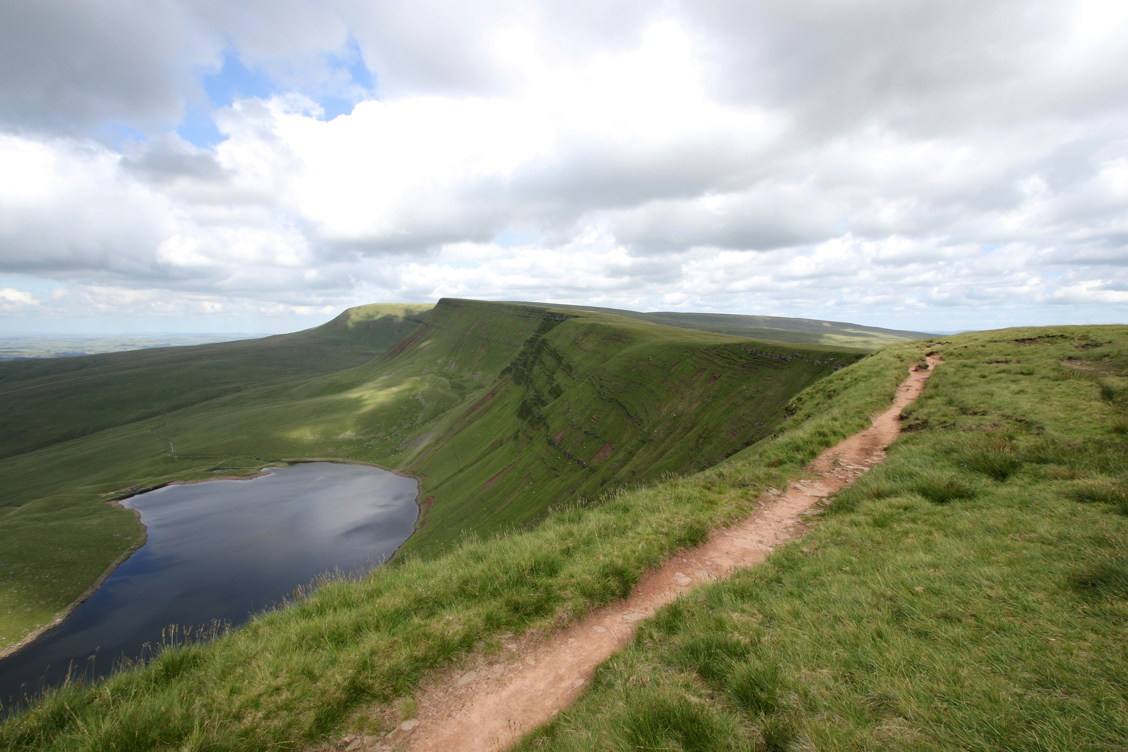 A trail atop a meadow-covered ridge at Llyn y Fan Fach, Wales