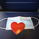 Heart shape on a protective mask with is on the plane tray