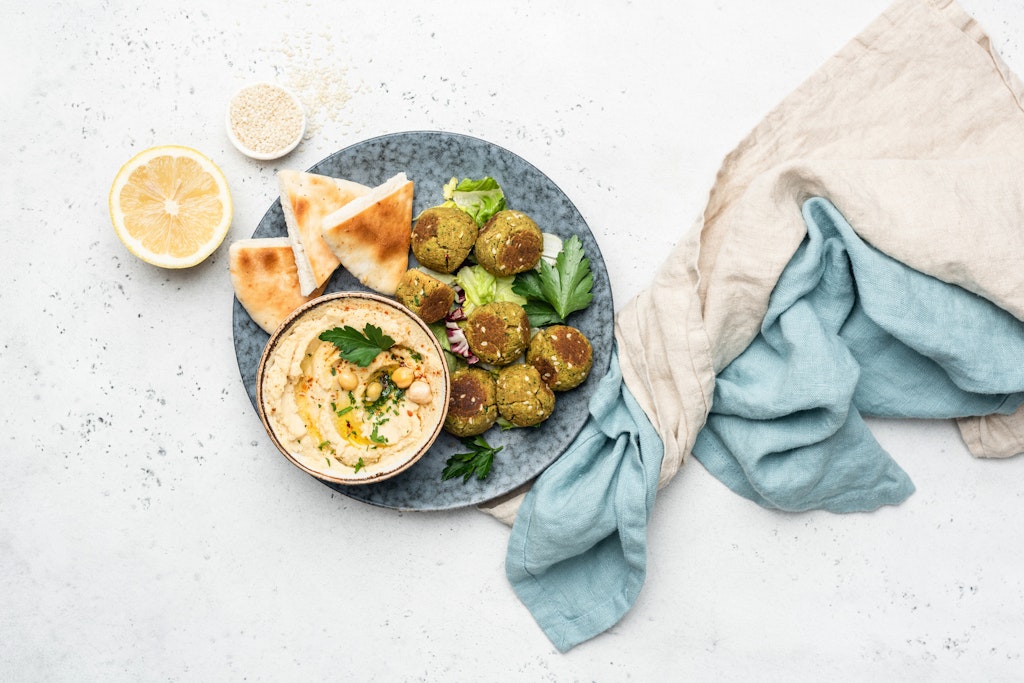 Falafel, hummus and pita bread. Arabian style appetizer. Healthy vegan and vegetarian food concept. Table top view, concrete background.
