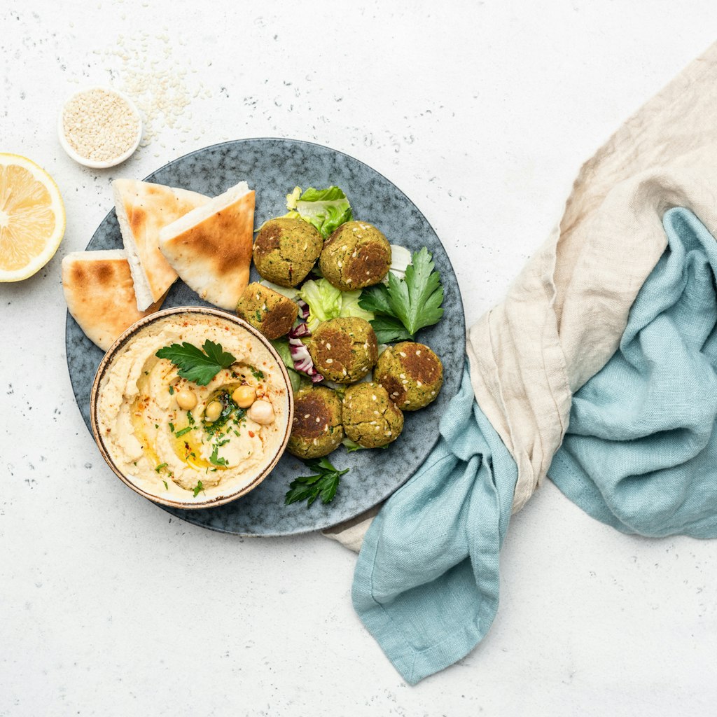 Falafel, hummus and pita bread. Arabian style appetizer. Healthy vegan and vegetarian food concept. Table top view, concrete background.