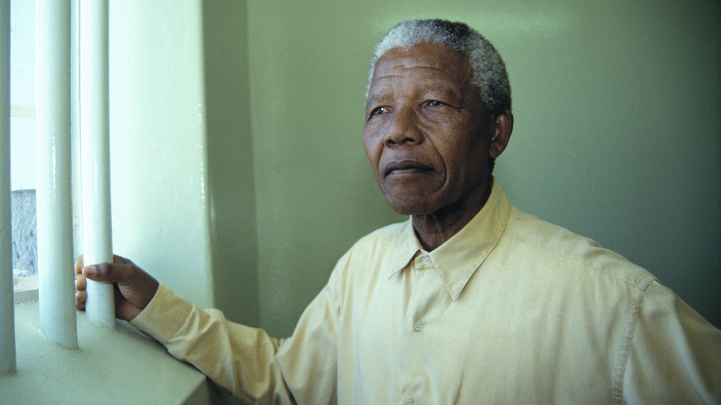 Nelson Mandela revisits the cell at Robben Island prison in February 1994 where he was jailed for more than two decades. 