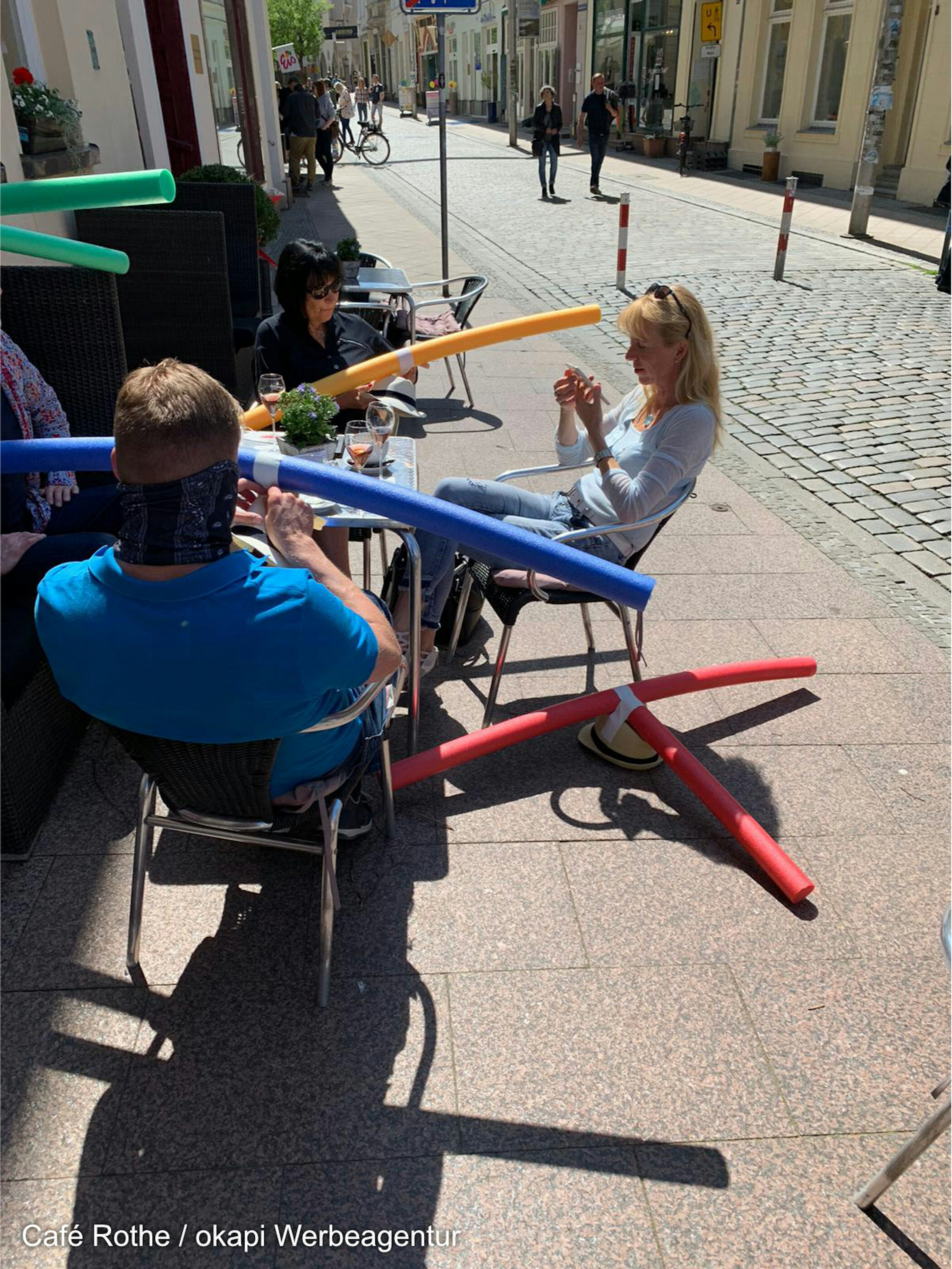 A picture of the cafe's patrons wearing the pool noodle hats