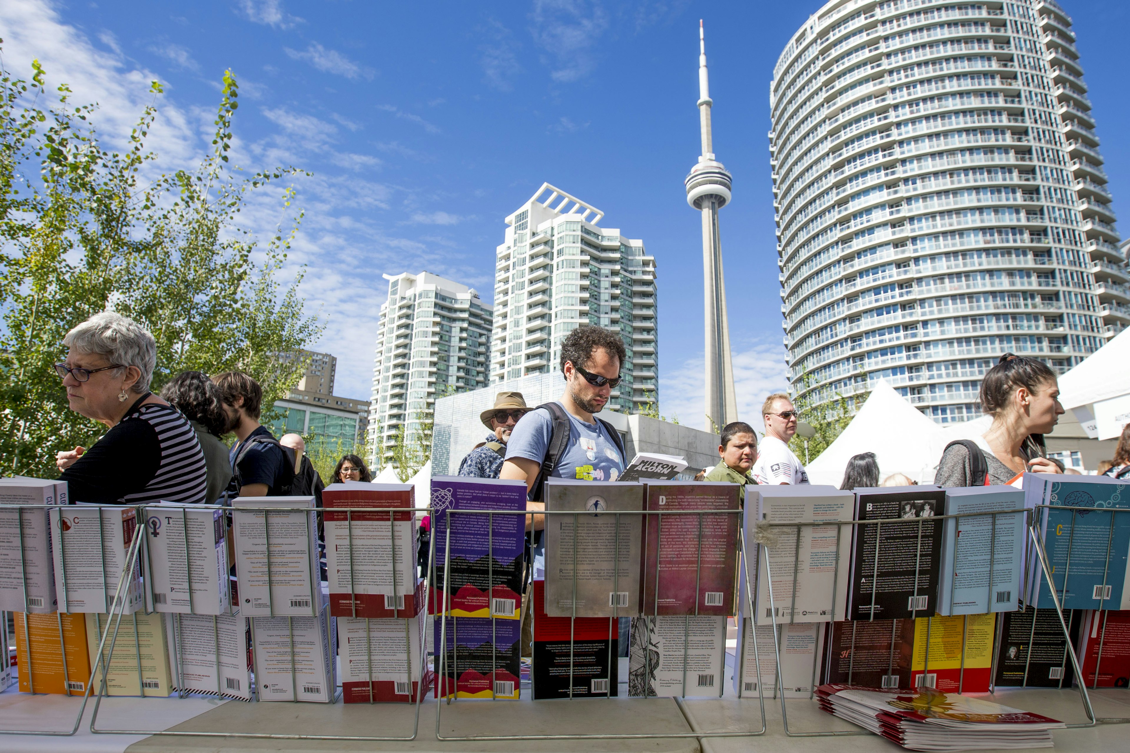 People browse for books on a stall outside in Toronto on a sunny day