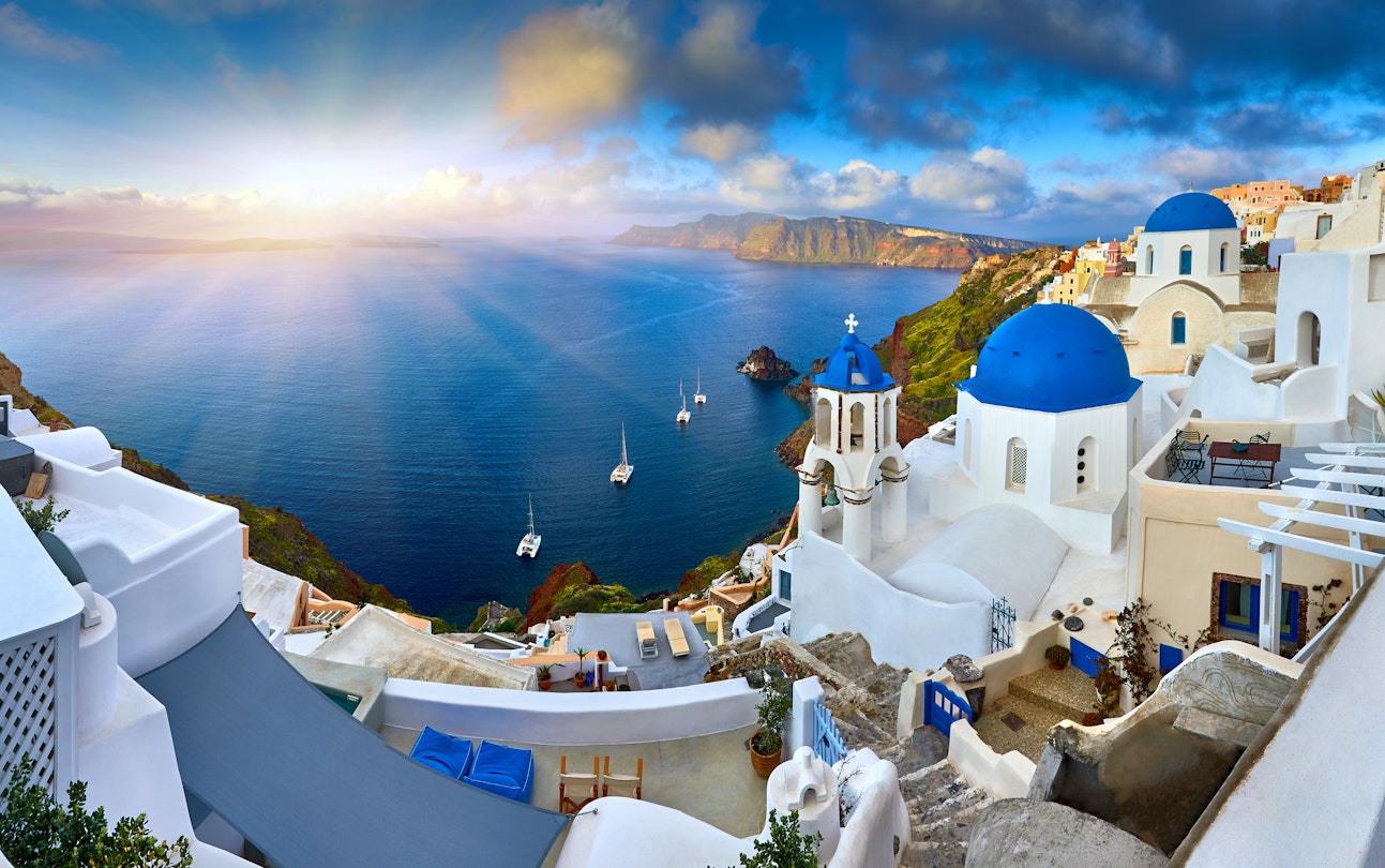 Fira town on Santorini island, Greece. Incredibly romantic sunrise on Santorini. Oia village in the morning light. Amazing sunset view with white houses. Island lovers. 3 Blue domes