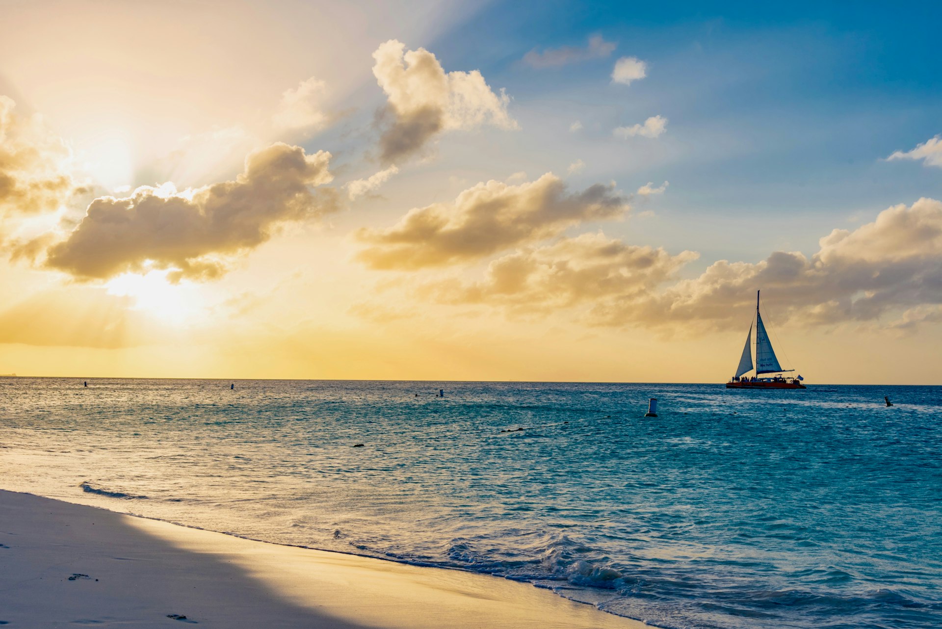 A sailing boat on the ocean at sunset during winter in Aruba