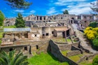 The ancient city of Pompeii with ruined houses and stone streets.