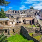 The ancient city of Pompeii with ruined houses and stone streets.