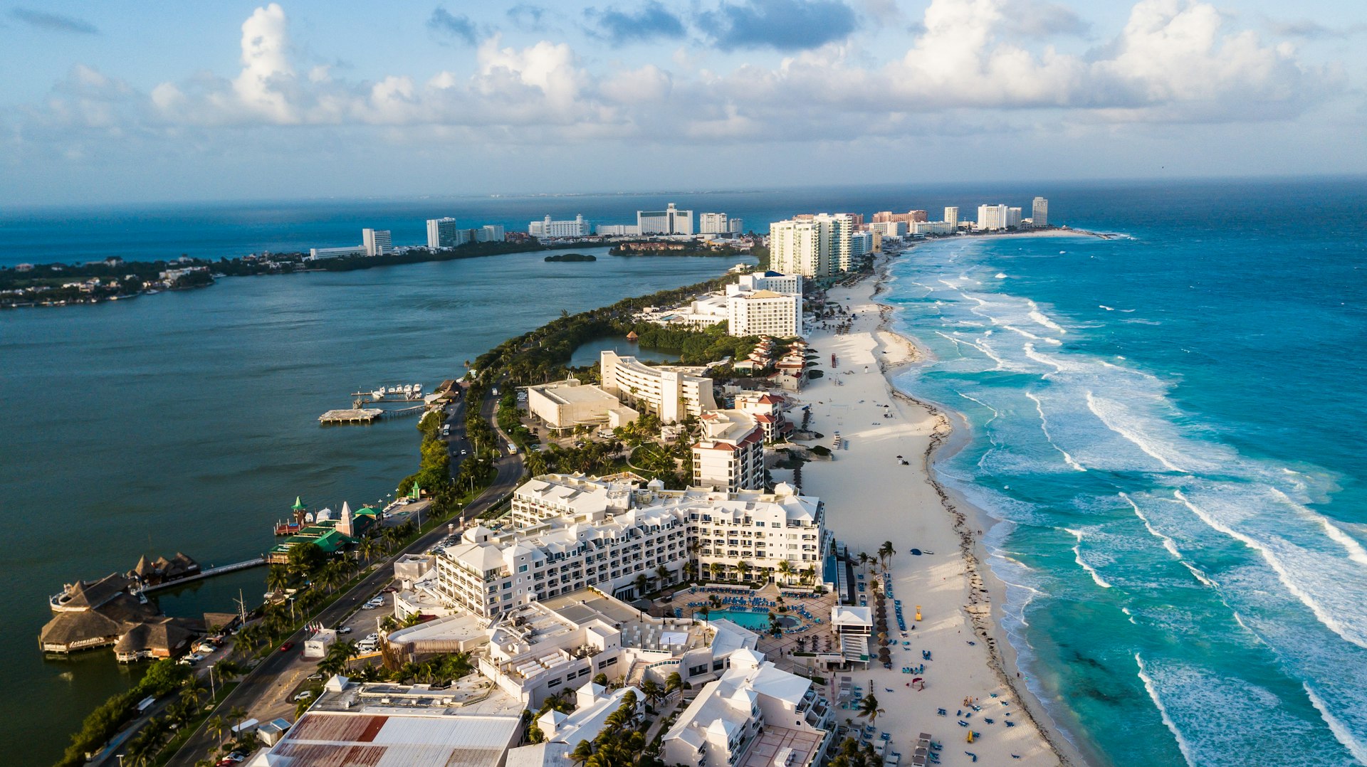 An aerial shot of a heavily developed strip of land with ocean on one side and a lagoon on the other