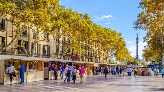 OCTOBER 26, 2014: People walking past market stalls on the La Rambla street in Barcelona.