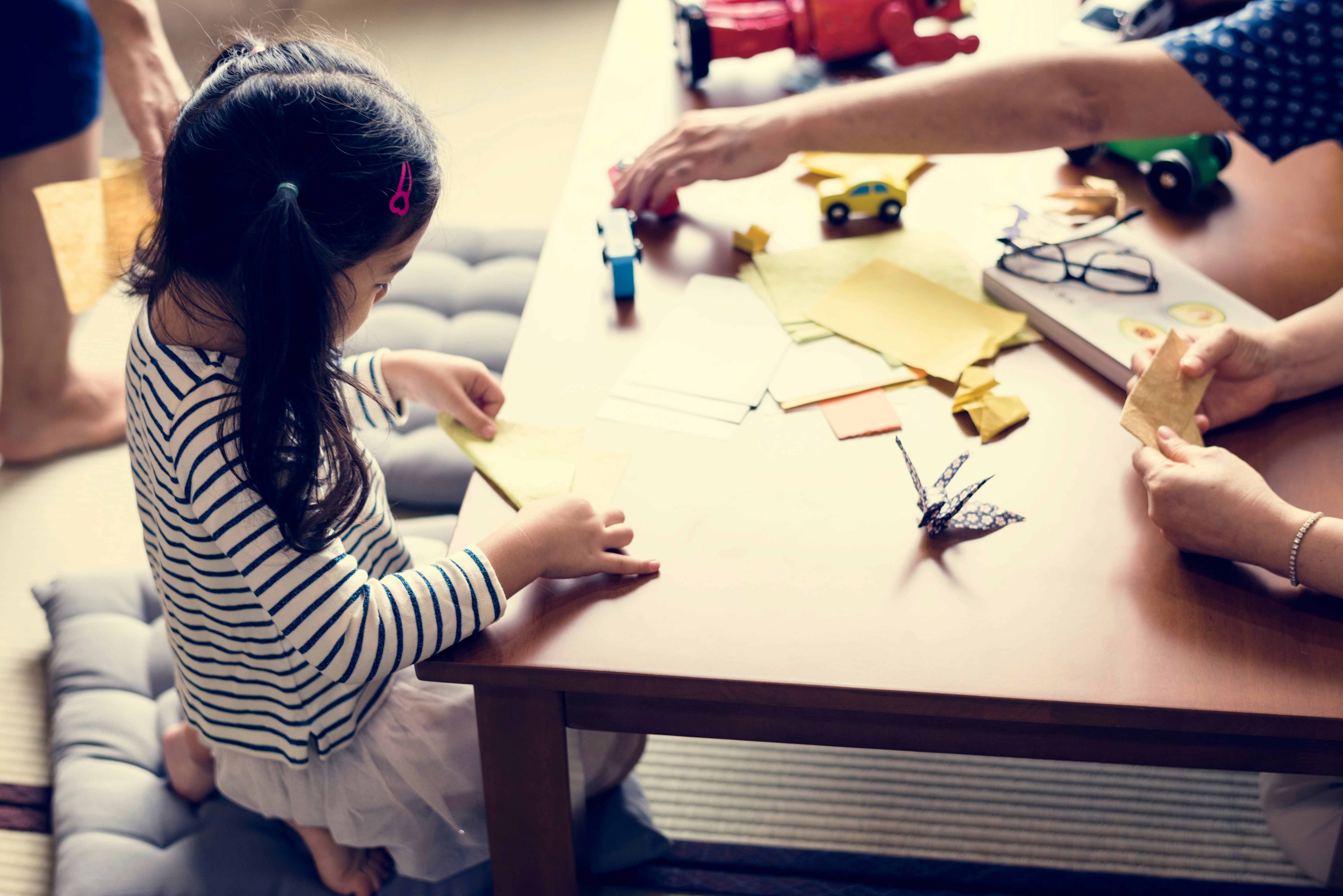 Japanese girl playing with origami on a table