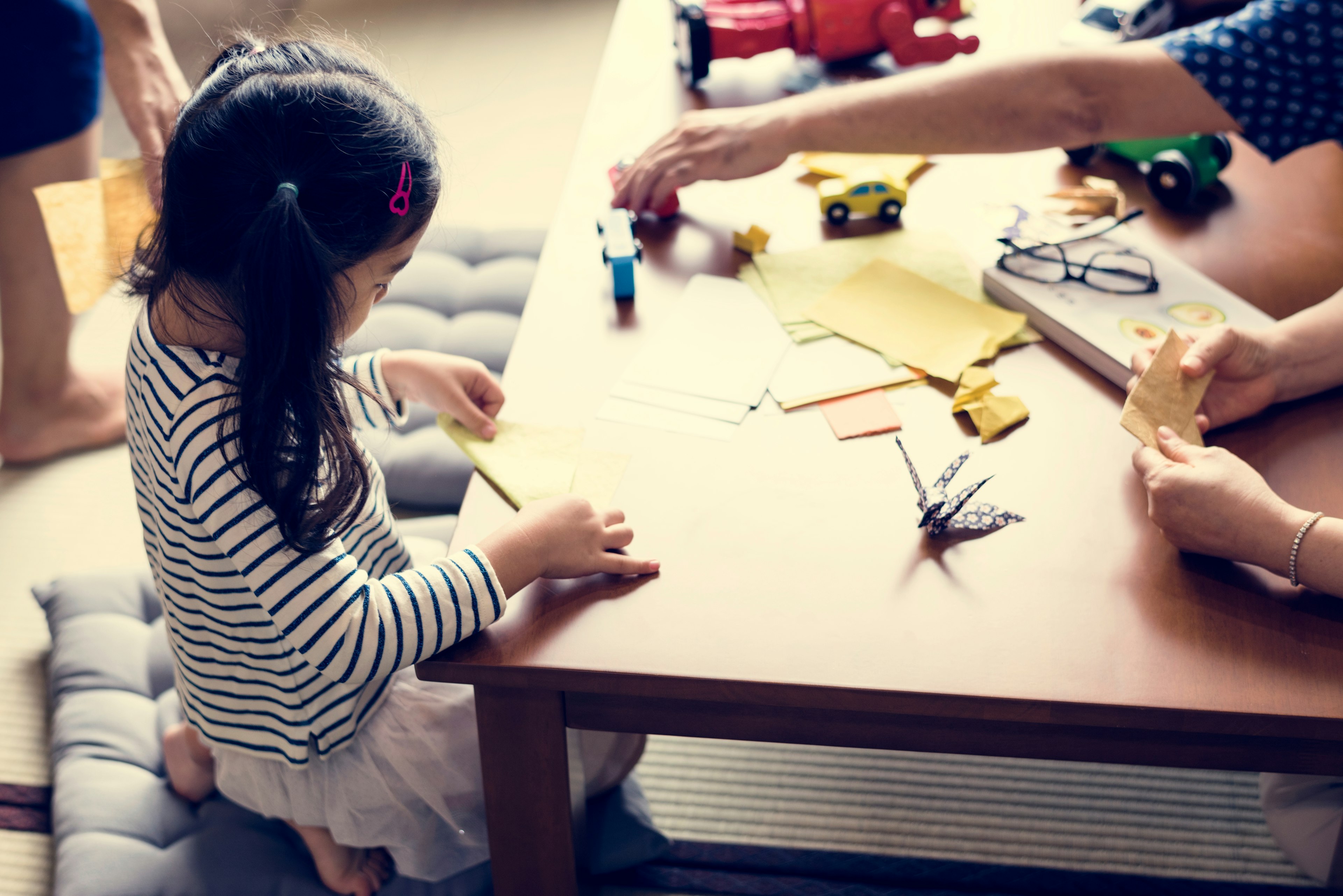 Japanese girl playing with origami on a table