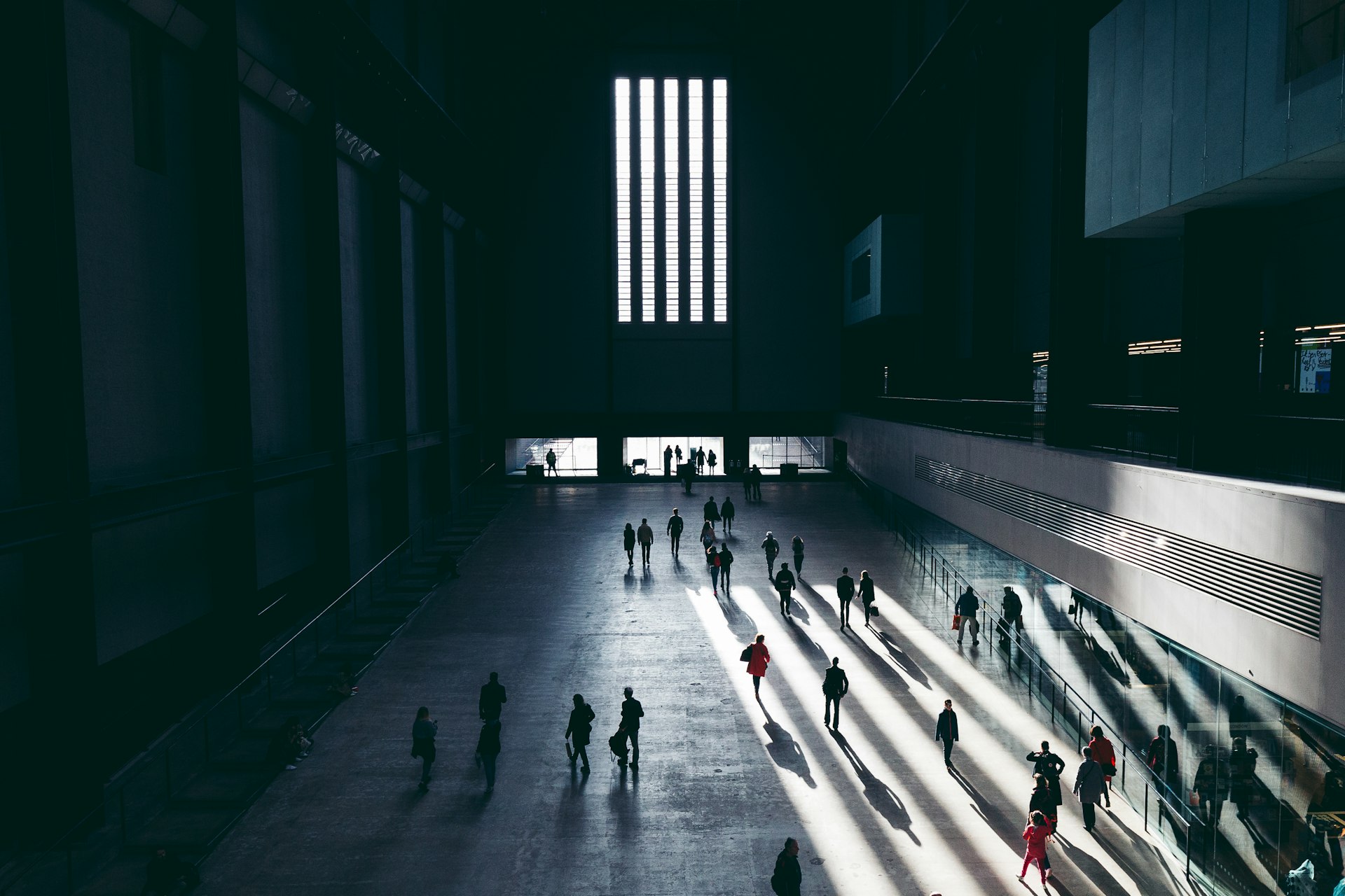 A large open space, the Turbine Hall in the Tate Modern, with people milling around.