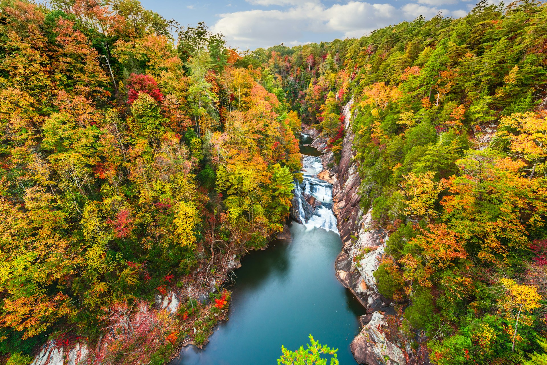 A high-angle view of a gorge surrounded by fall colors