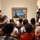 May 25, 2018: Crowd of people surround the Starry Night painting by Vincent van Gogh inside the Museum of Modern Art.
