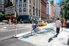 June 20, 2018: Cyclist riding in a bike lane at the Park Row financial district.