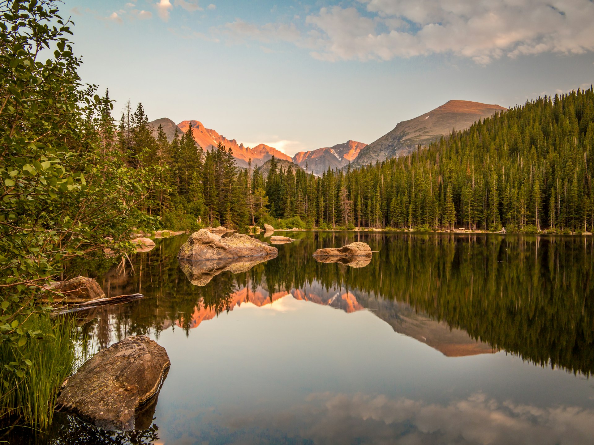 Sunset reflection of mountains and rocks at Bear Lake in Rocky Mountain National Park, Colorado