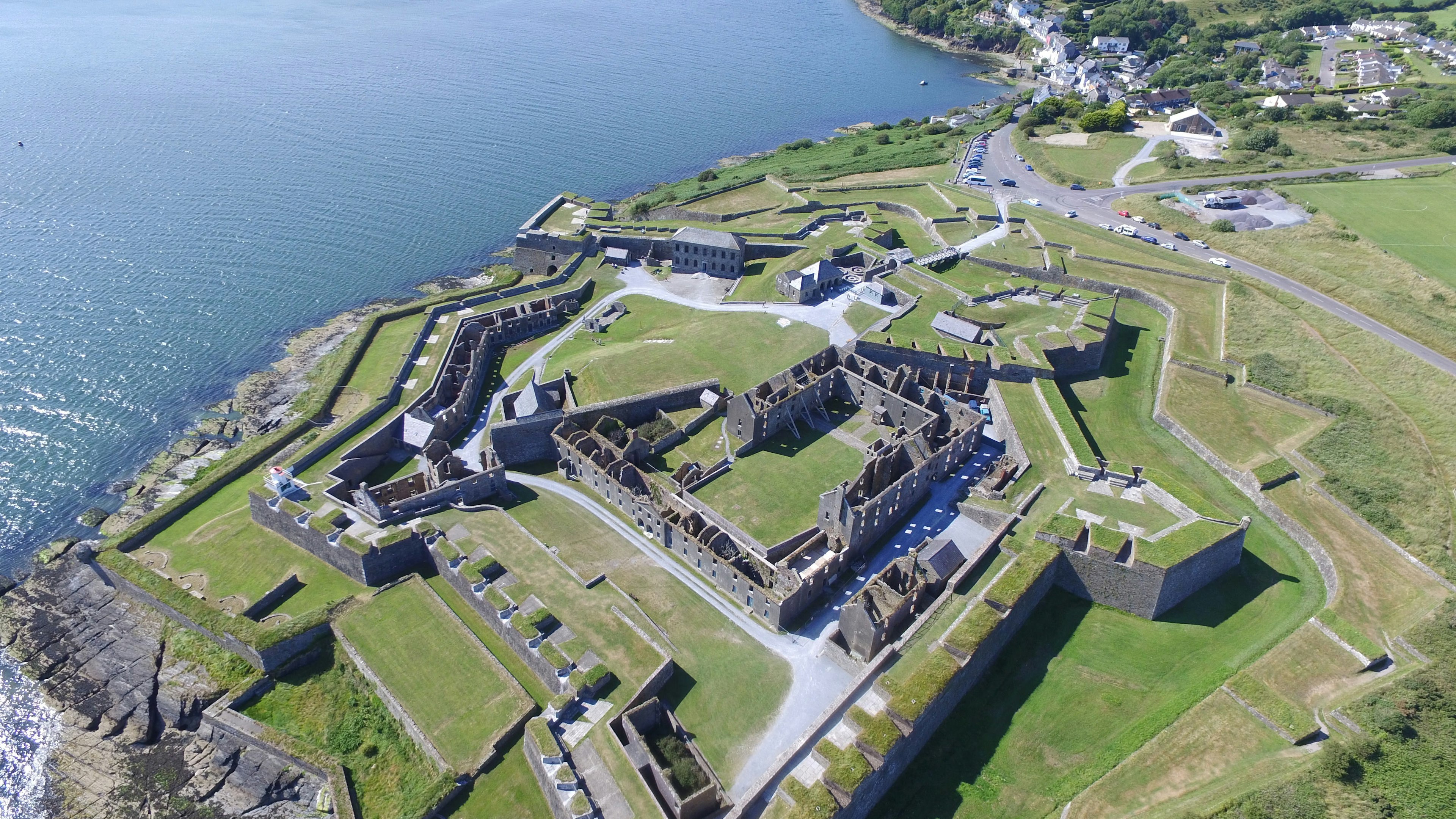 An aerial shot of a star-shaped fort on a cliff edge