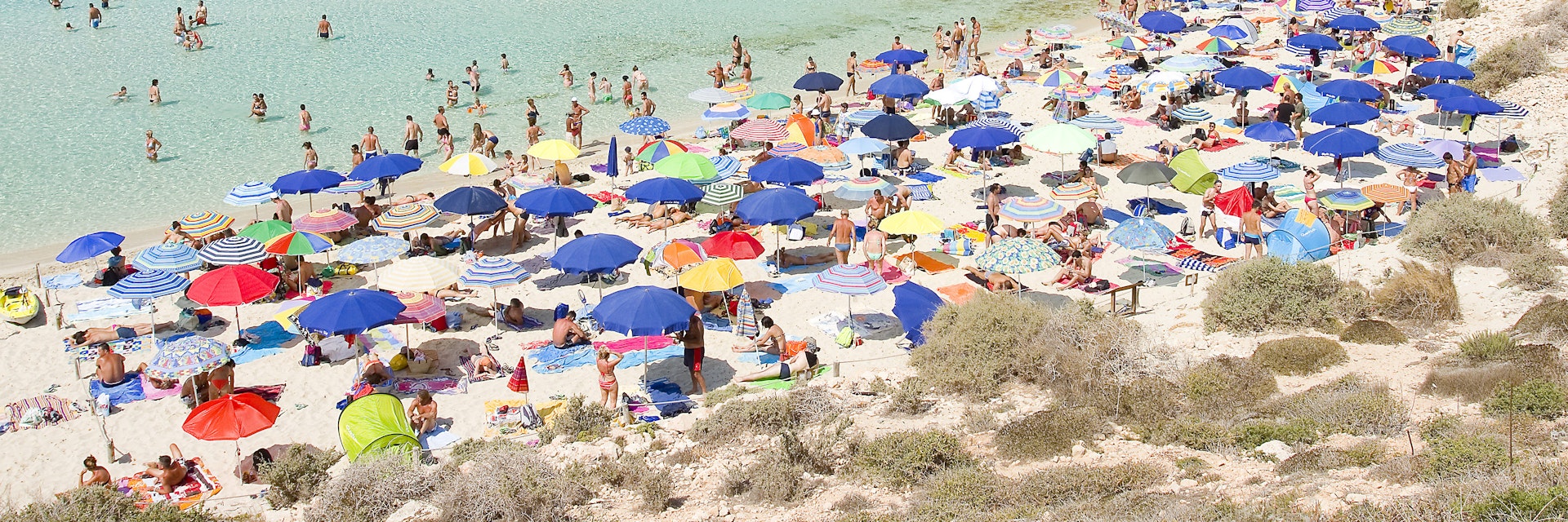Tourists on the beach Spiaggia dei Conigli on Lampedusa, Sicily, Italy.
