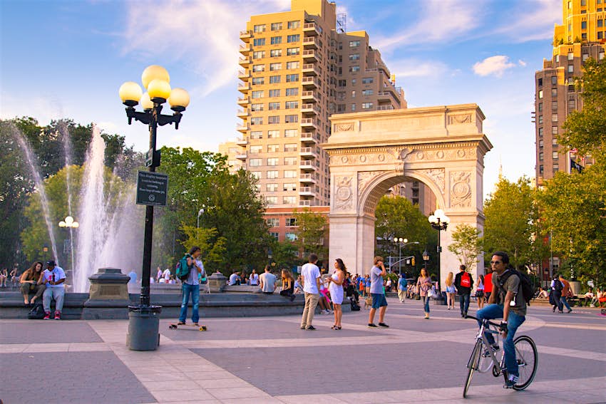shutterstockRF_158411888.jpg People walk and a person rides a bike during a summer evening at Washington Square Park in Manhattan