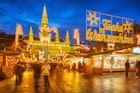 Traditional Christmas market in Vienna lit up at night.