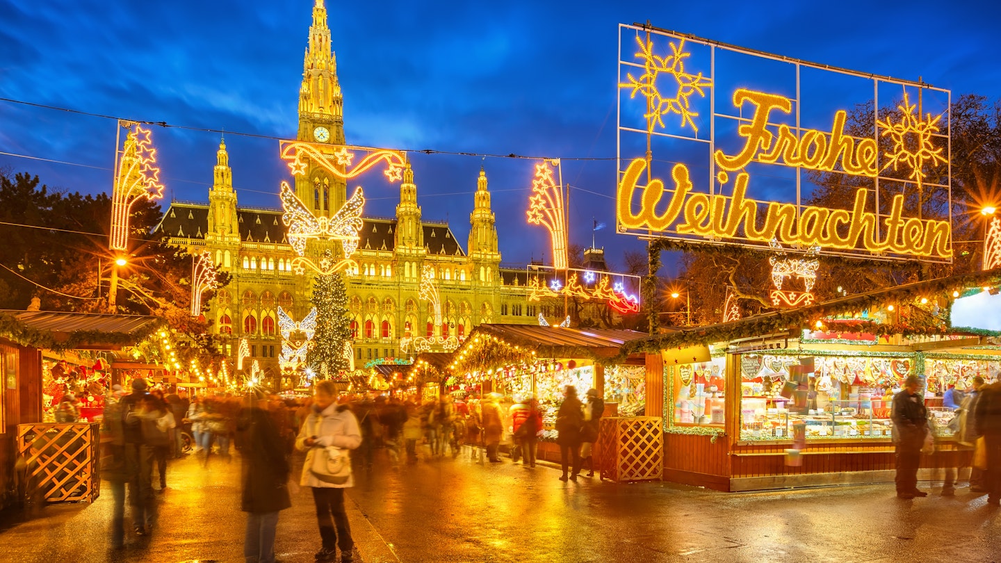 Traditional Christmas market in Vienna lit up at night.