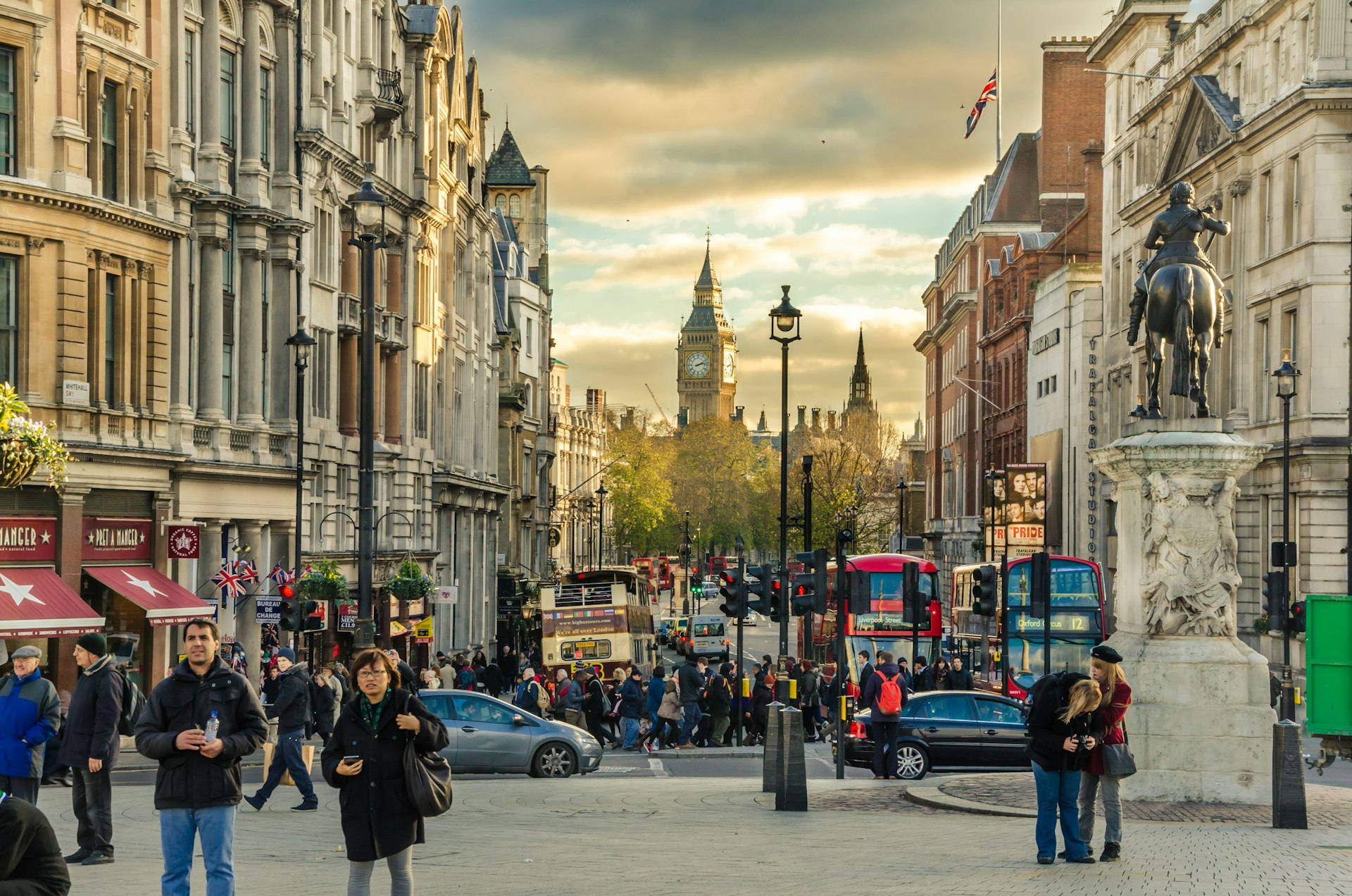 London's Whitehall Street at sunset, crowded with tourists and commuters