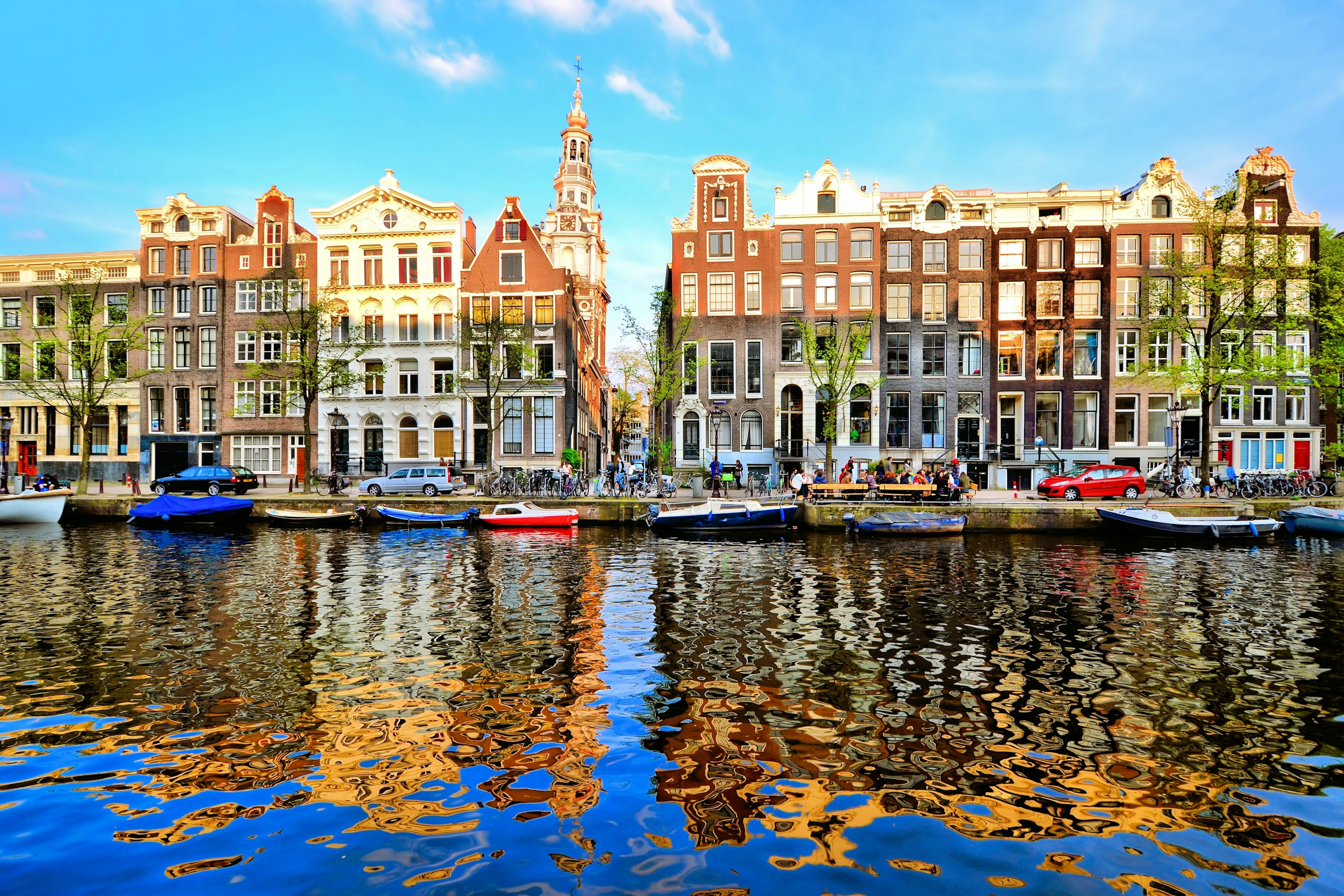 Canal houses of Amsterdam at dusk with vibrant reflections, Netherlands