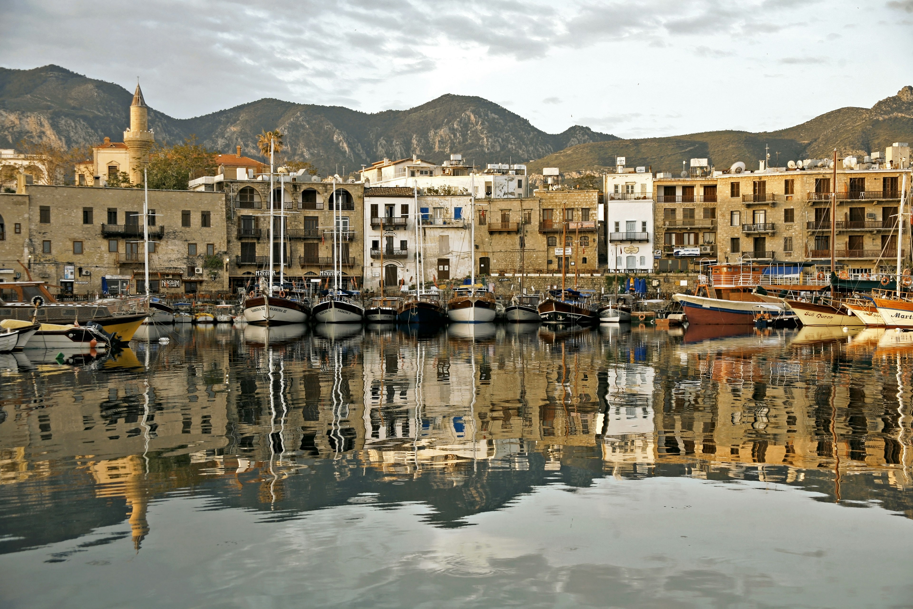 Girne harbour with boats and houses and reflections Marina of Kyrenia in Northern Cyprus