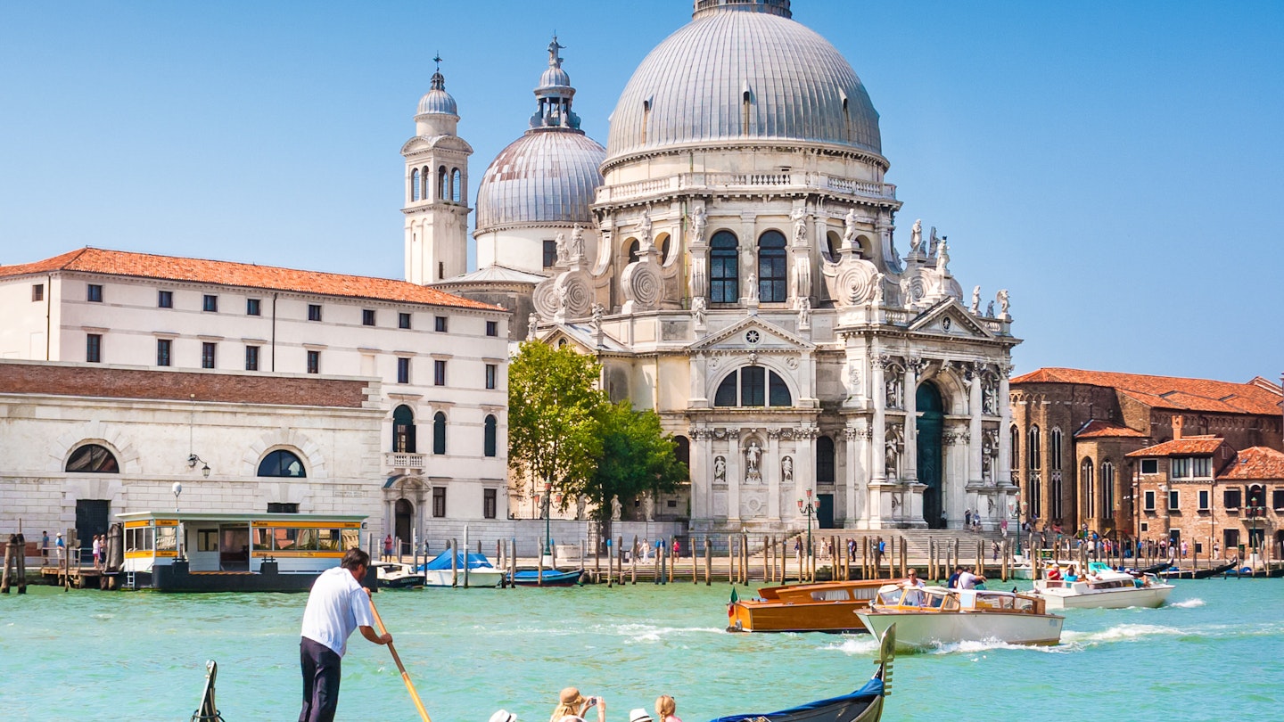 Traditional Gondola on Canal Grande with Basilica di Santa Maria della Salute in the background, Venice, Italy