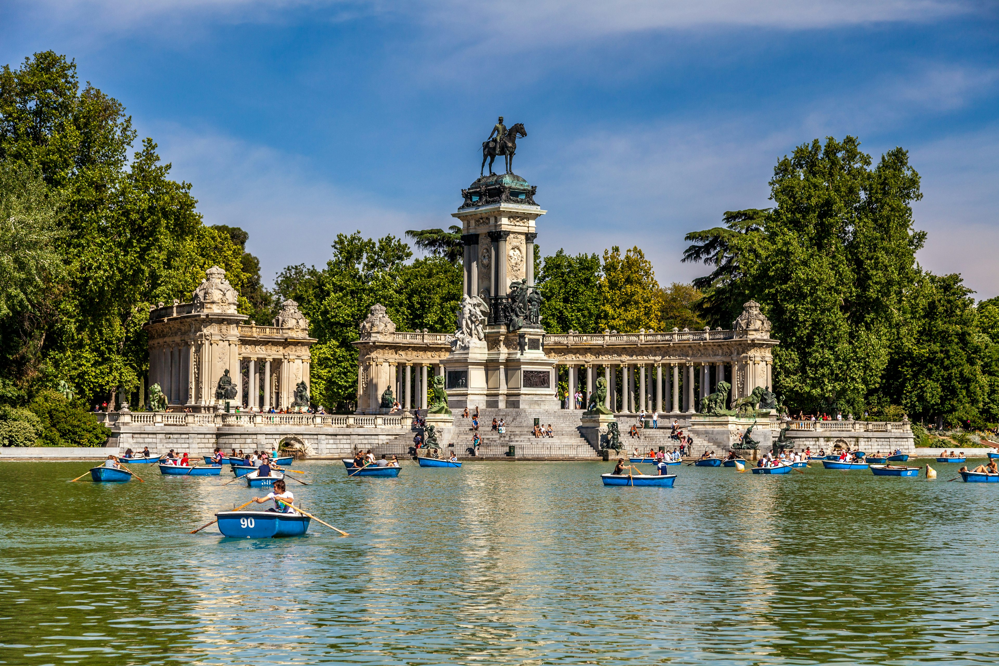 People riding small boats at Parque del Buen Retiro