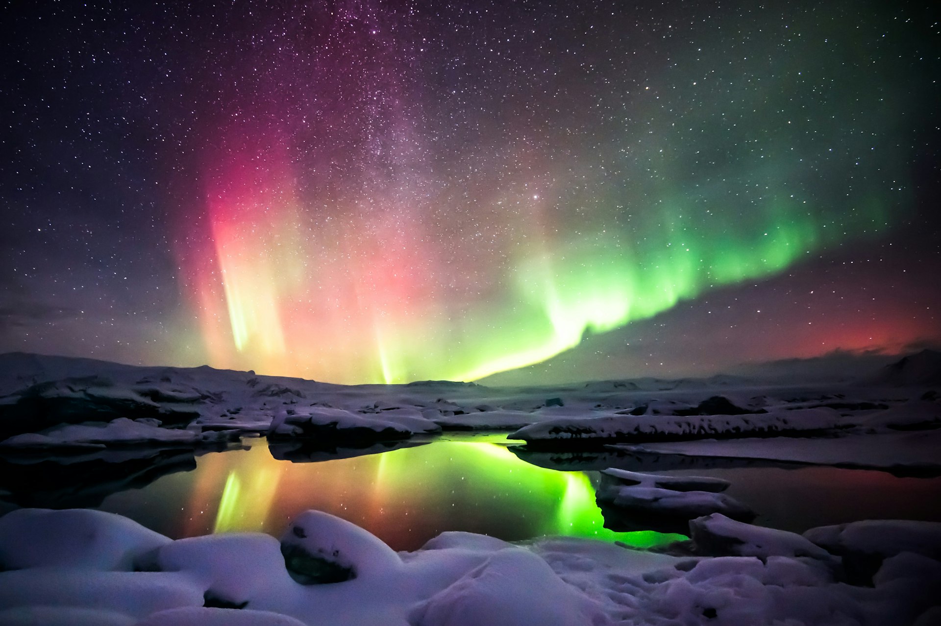 A green and red aurora over the Jokulsarlon lagoon in Iceland