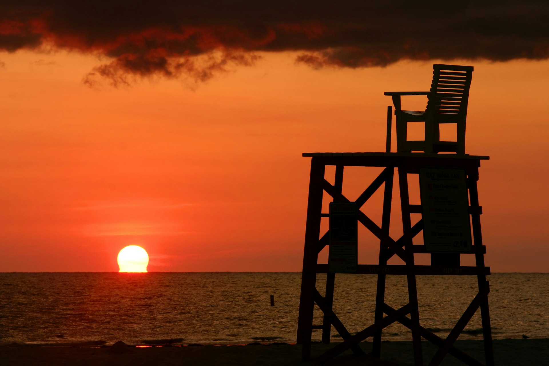 Lifeguard chair in silhouette during the sun set at Fort Desoto Park near St. Petersburg, Florida
