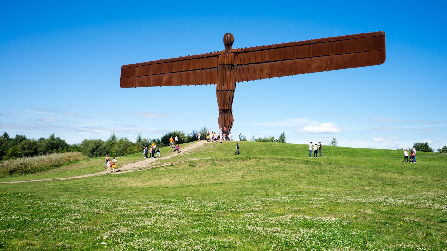 AUGUST 13th, 2015: Visitors at the Angel of the North, a steel sculpture by Antony Gormley, which stands 20 meters high.