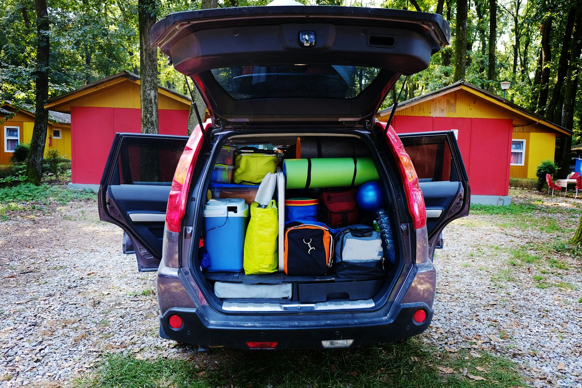 The open trunk of a car, packed full of luggage