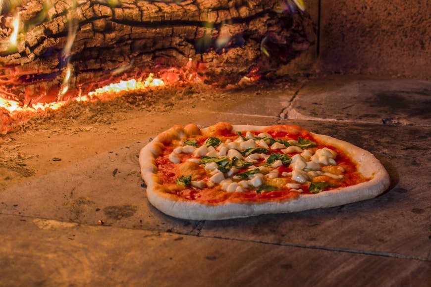 Margherita pizza in a wood oven in Italy.